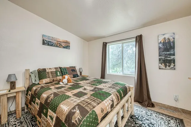 a bedroom with a bed and a window