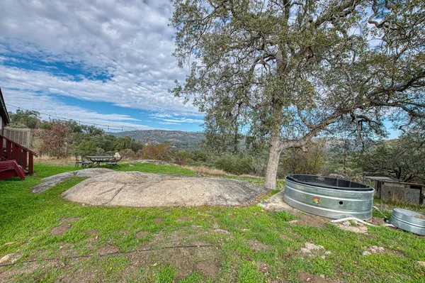a view of a yard with an outdoor seating