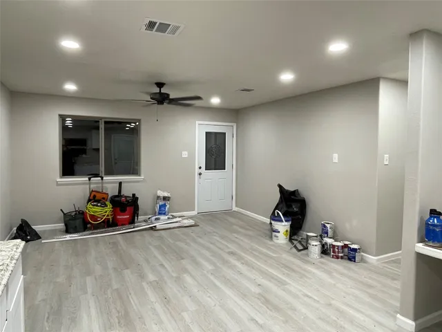 a room with gym equipment and a flat screen tv