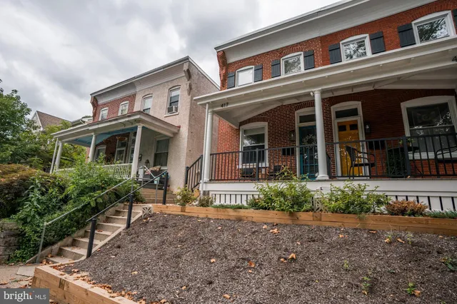 front view of a brick house with a small yard