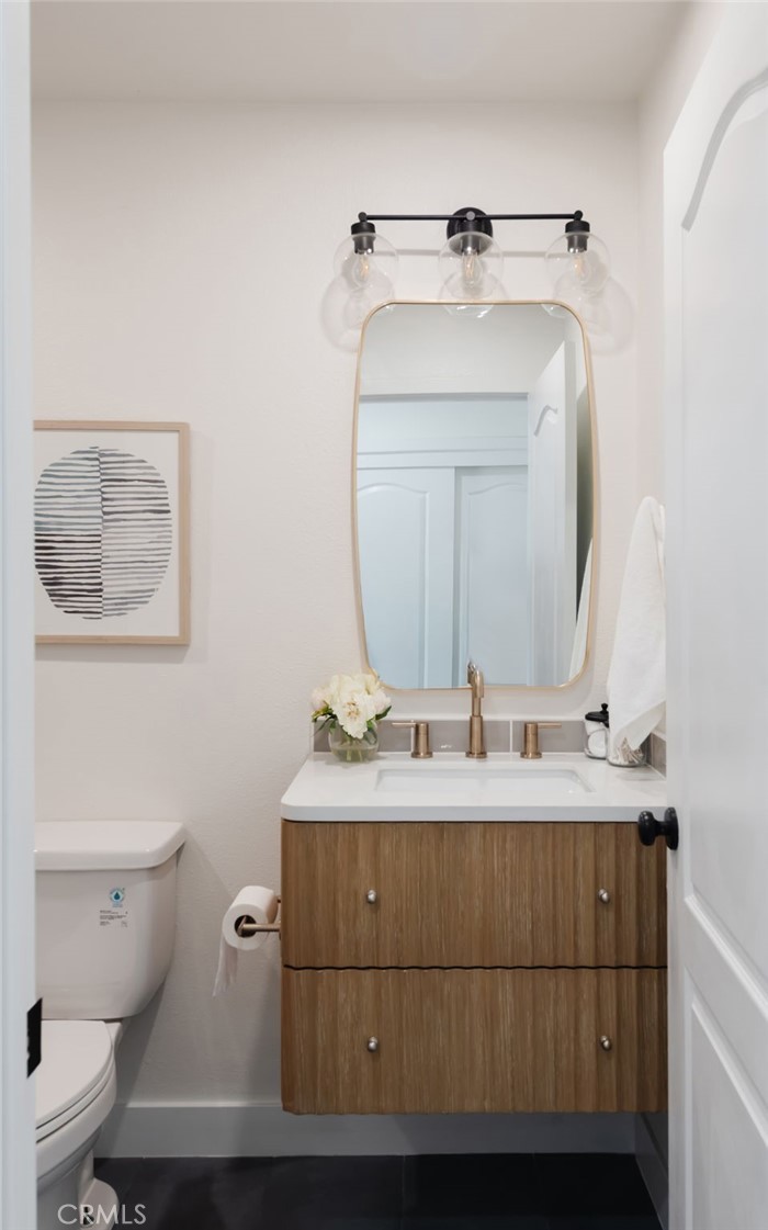 1044 252nd Street, Unit 4 Harbor City, CA 90710 - Photo 19 of 41 a bathroom with a toilet sink and mirror