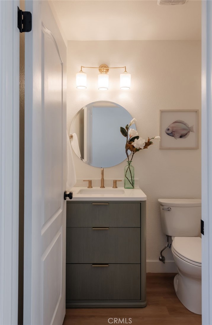 1044 252nd Street, Unit 4 Harbor City, CA 90710 - Photo 20 of 41 a bathroom with a sink a toilet and mirror
