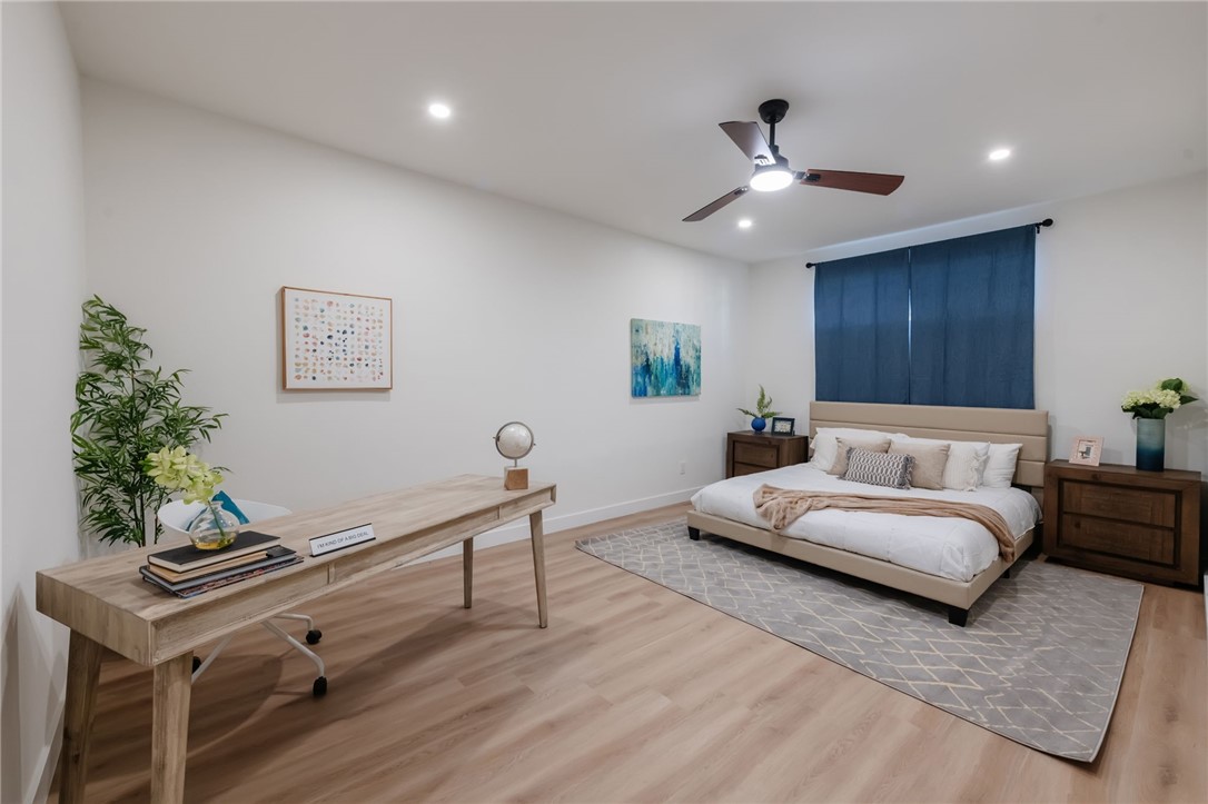 1044 252nd Street, Unit 4 Harbor City, CA 90710 - Photo 21 of 41 a spacious bedroom with a bed and a chandelier