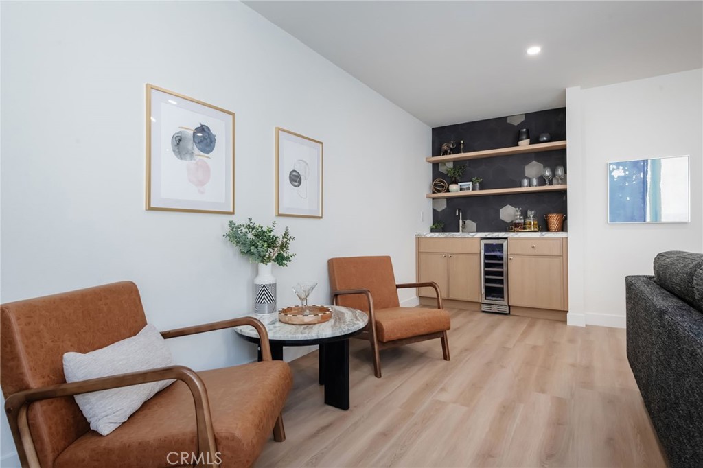 1044 252nd Street, Unit 4 Harbor City, CA 90710 - Photo 27 of 41 a living room with furniture a rug and white walls
