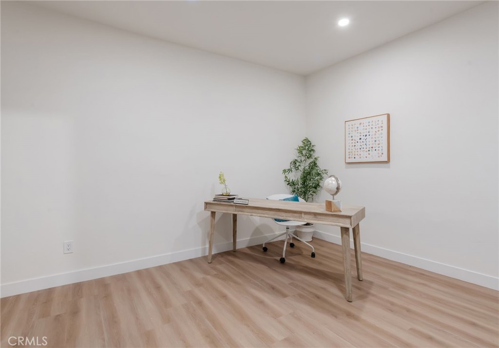 1044 252nd Street, Unit 4 Harbor City, CA 90710 - Photo 28 of 41 a view of a workspace with furniture and wooden floor