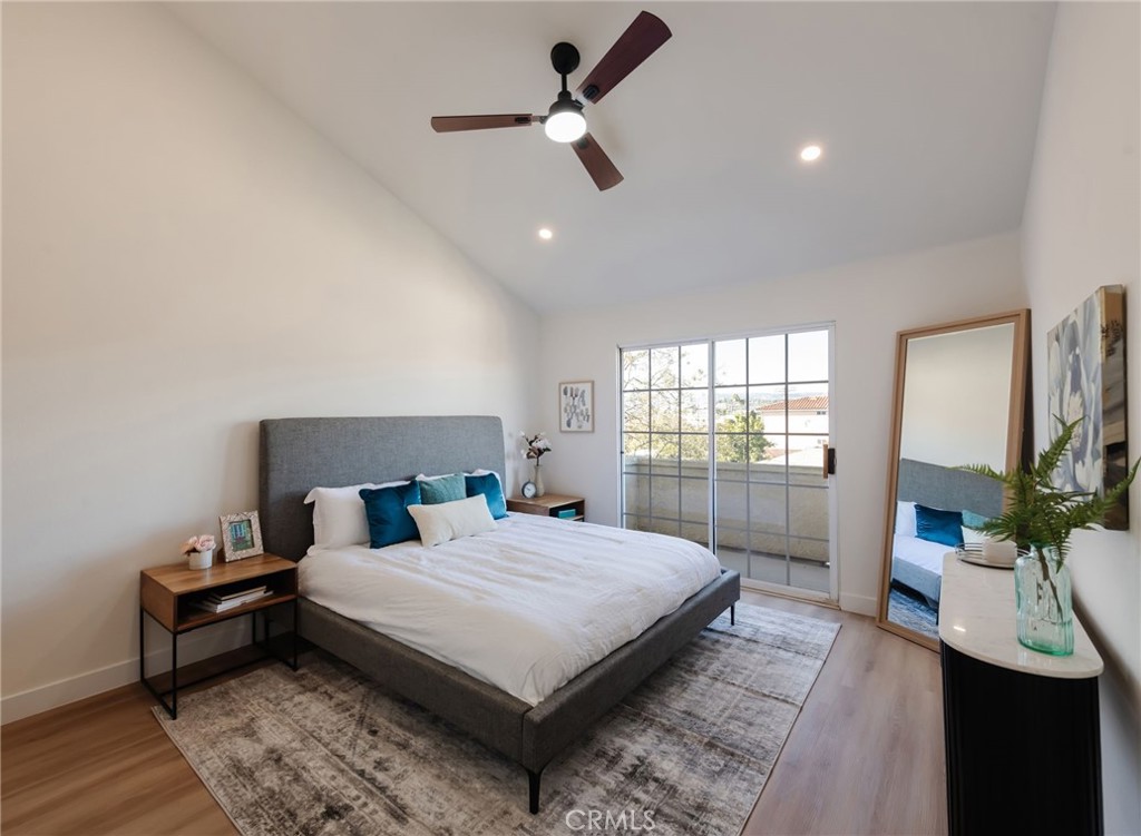 1044 252nd Street, Unit 4 Harbor City, CA 90710 - Photo 30 of 41 a bedroom with a bed a flat screen tv and a couch