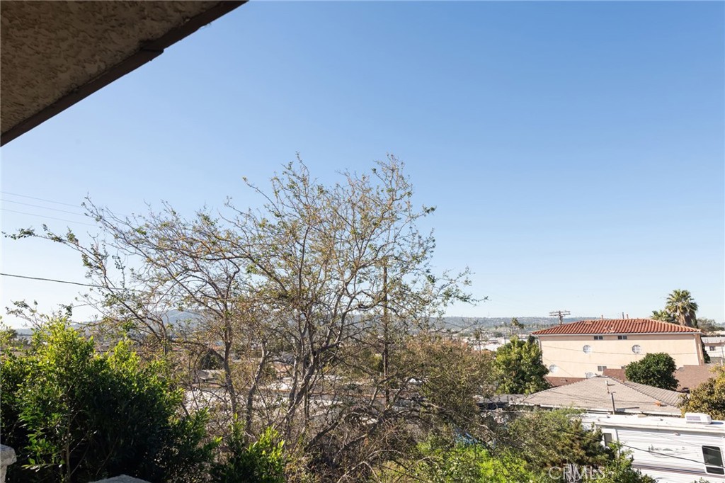 1044 252nd Street, Unit 4 Harbor City, CA 90710 - Photo 31 of 41 a view of a yard with an outdoor space and trees