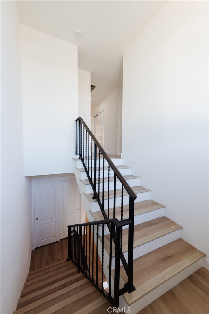 1044 252nd Street, Unit 4 Harbor City, CA 90710 - Photo 36 of 41 a view of staircase with wooden floor and white walls