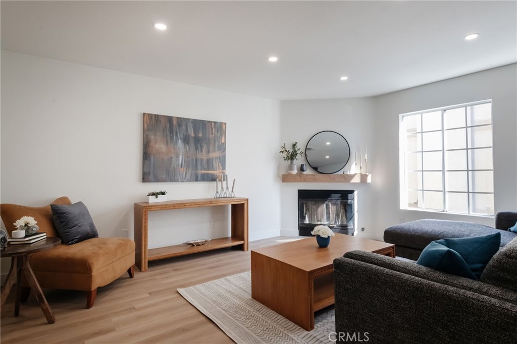 1044 252nd Street, Unit 4 Harbor City, CA 90710 - Photo 5 of 41 a living room with furniture and a fireplace