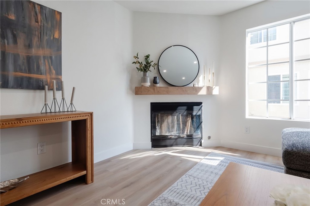 1044 252nd Street, Unit 4 Harbor City, CA 90710 - Photo 8 of 41 a view of an empty room with a fireplace and a window