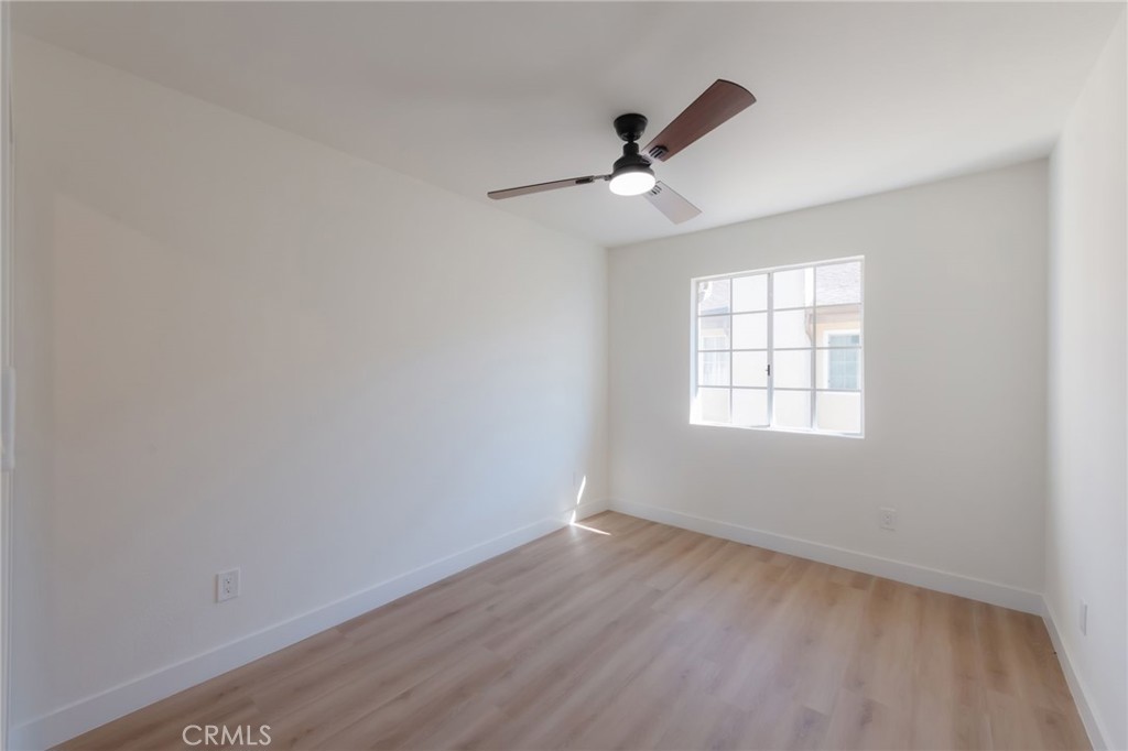 1044 252nd Street, Unit 4 Harbor City, CA 90710 - Photo 10 of 41 wooden floor in an empty room with a window