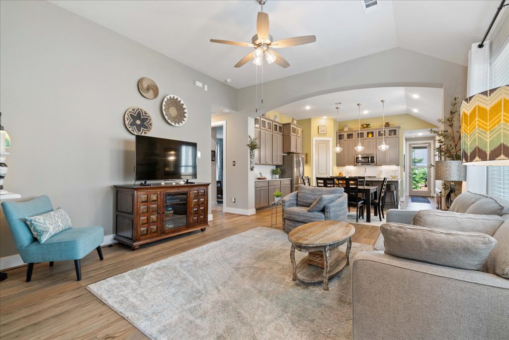 7912 Prairie Rye Drive Lago Vista, TX 78645 - Photo 8 of 37 Bright and open living space featuring soaring ceilings, abundant natural light, and seamless flow into the kitchen and dining areas.