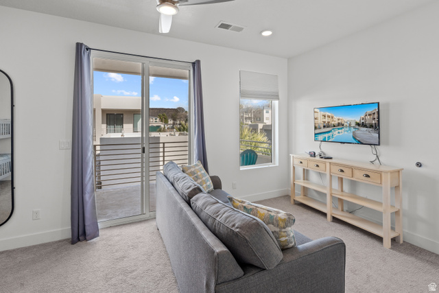 1122 South 1790th West, Unit 1 St. George, UT 84770 - Photo 19 of 37 Carpeted interior space featuring a sliding glass door opening to a private balcony with horizontal railings