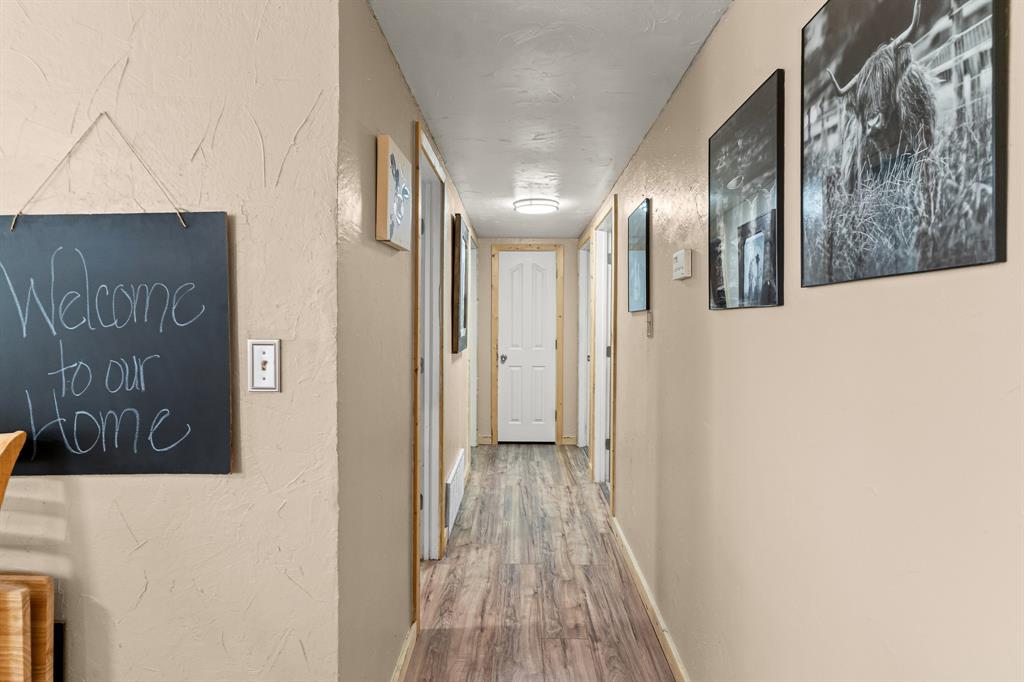 108 Paige Street Weatherford, TX 76088 - Photo 13 of 34 a view of a hallway with wooden floor