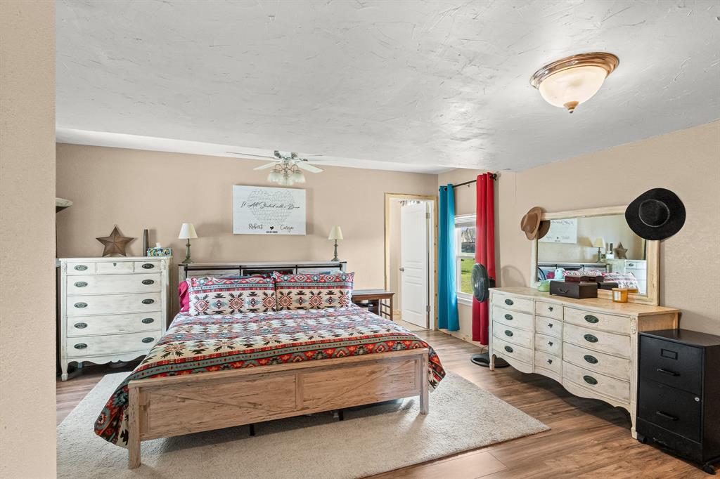 108 Paige Street Weatherford, TX 76088 - Photo 14 of 34 a bedroom with a bed and a cabinets