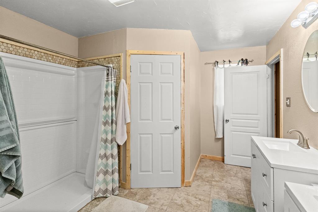 108 Paige Street Weatherford, TX 76088 - Photo 18 of 34 a bathroom with a shower and a sink
