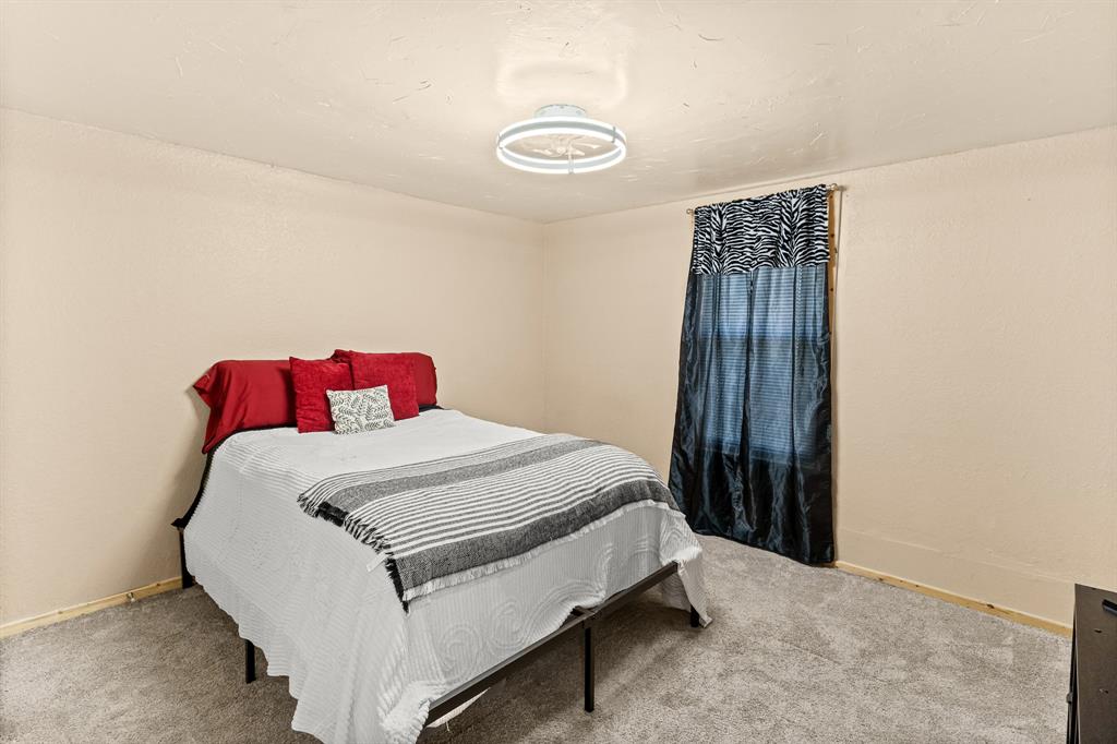 108 Paige Street Weatherford, TX 76088 - Photo 19 of 34 a bedroom with a bed and a window