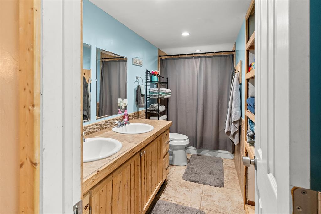 108 Paige Street Weatherford, TX 76088 - Photo 21 of 34 a bathroom with a sink a toilet and shower