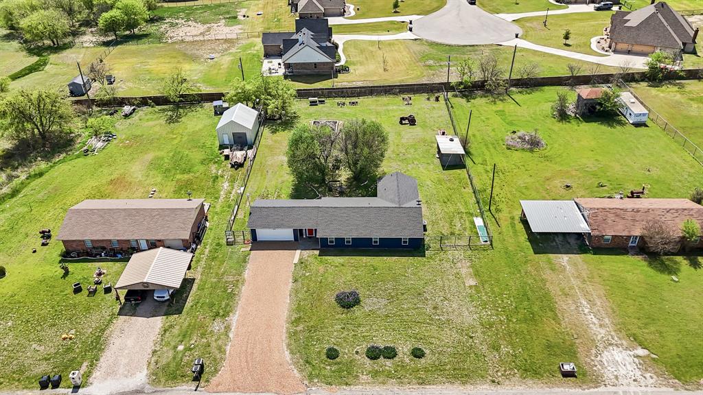 108 Paige Street Weatherford, TX 76088 - Photo 4 of 34 aerial view of a house with swimming pool lawn chairs and a yard