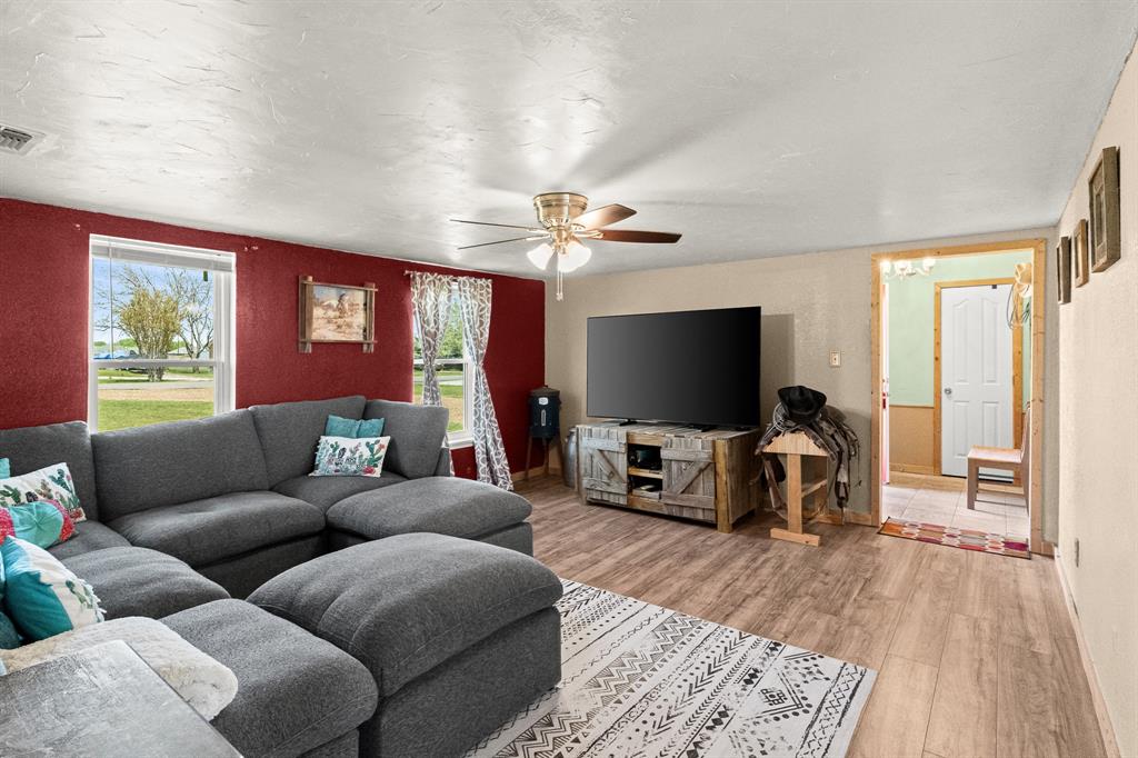 108 Paige Street Weatherford, TX 76088 - Photo 7 of 34 a living room with furniture and a flat screen tv