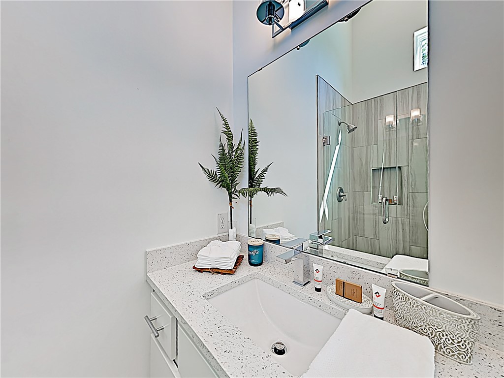 5314 Downs Drive, Unit A Austin, TX 78721 - Photo 12 of 19 a bathroom with a sink and a mirror