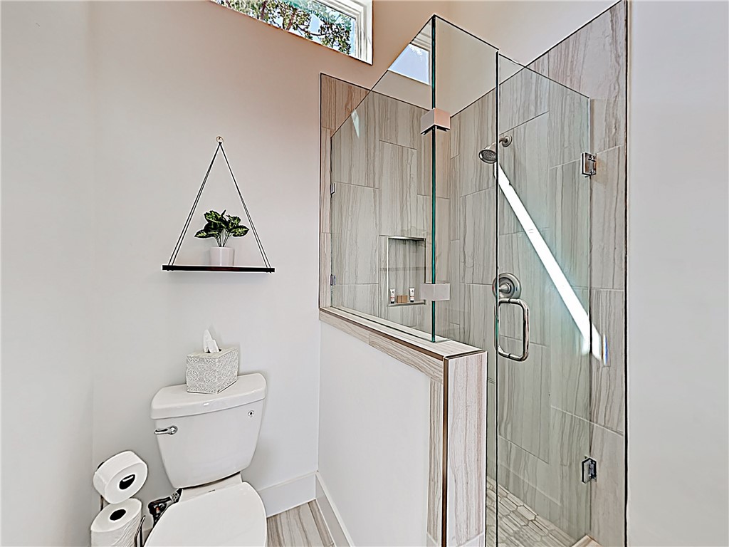 5314 Downs Drive, Unit A Austin, TX 78721 - Photo 13 of 19 a bathroom with a toilet sink and shower