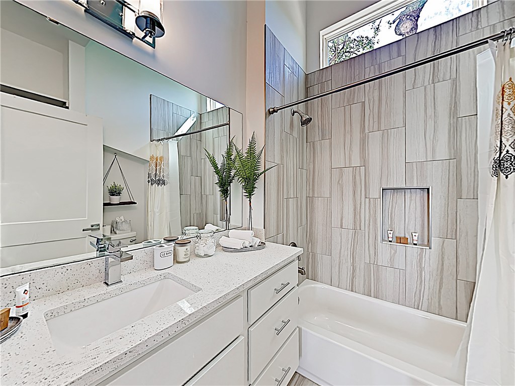 5314 Downs Drive, Unit A Austin, TX 78721 - Photo 17 of 19 a bathroom with a sink and a mirror