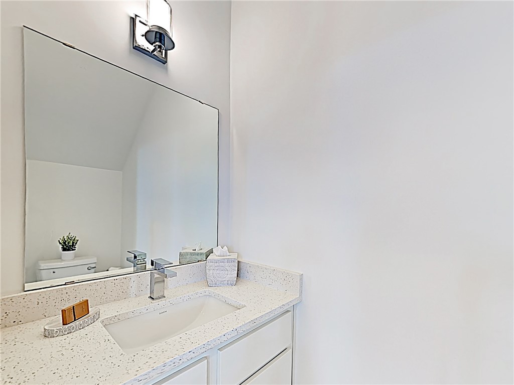 5314 Downs Drive, Unit A Austin, TX 78721 - Photo 18 of 19 a bathroom with a sink and a mirror