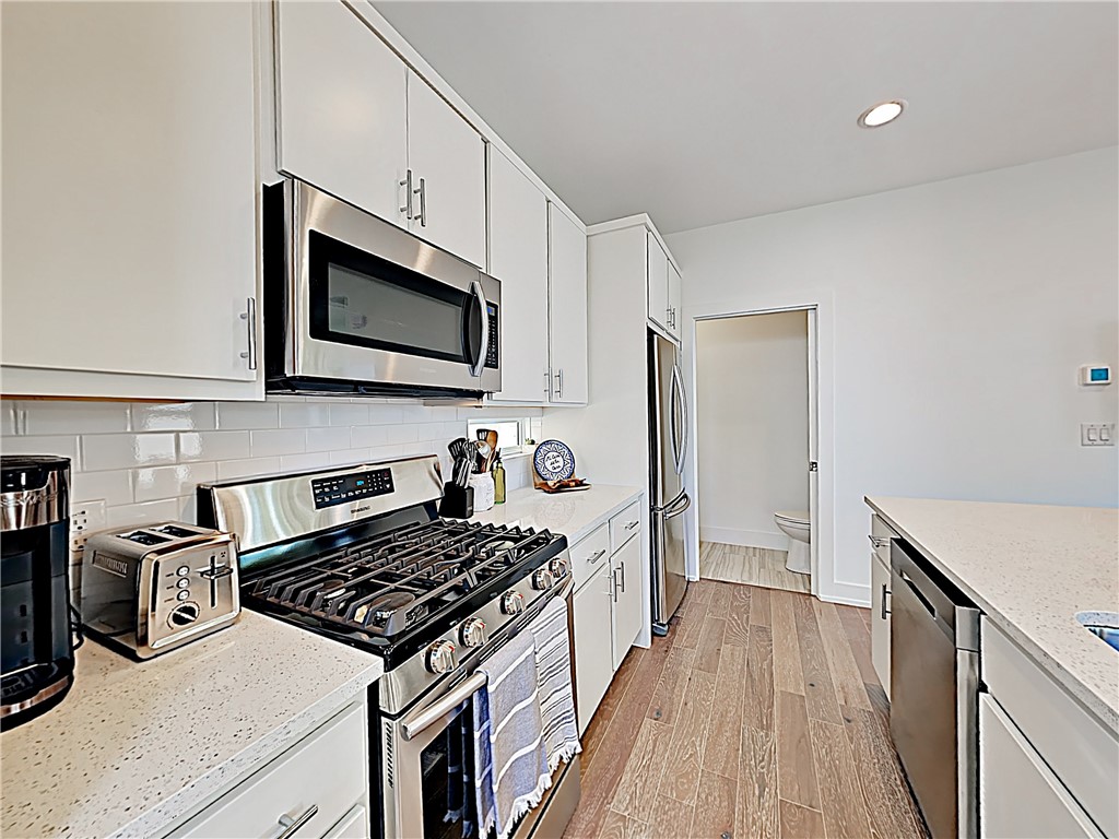 5314 Downs Drive, Unit A Austin, TX 78721 - Photo 7 of 19 a kitchen with a stove and a microwave