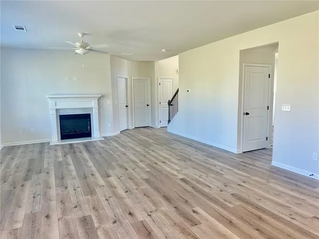 a view of an empty room and wooden floor
