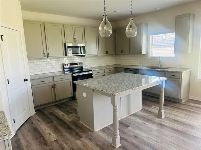 a kitchen with a sink stove and microwave