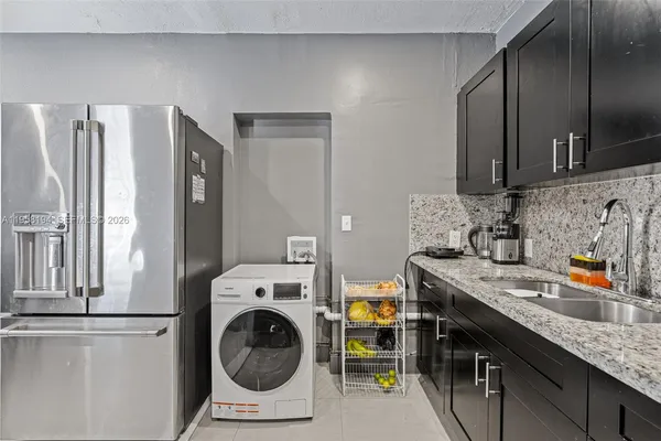 a utility room with sink dryer and washer