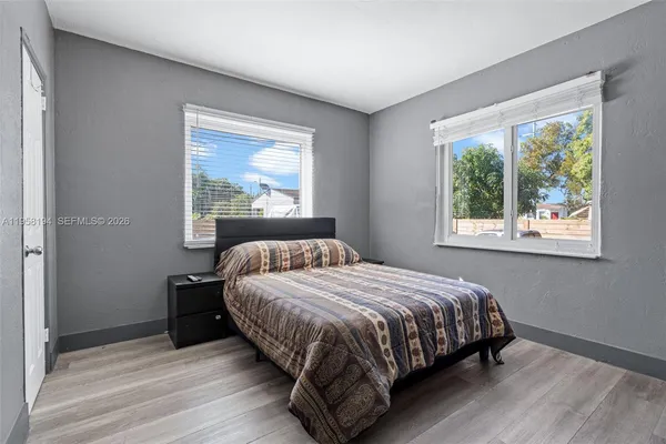 a bedroom with a bed lamp and window