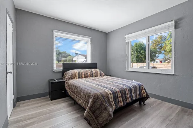 a bedroom with a bed lamp and window