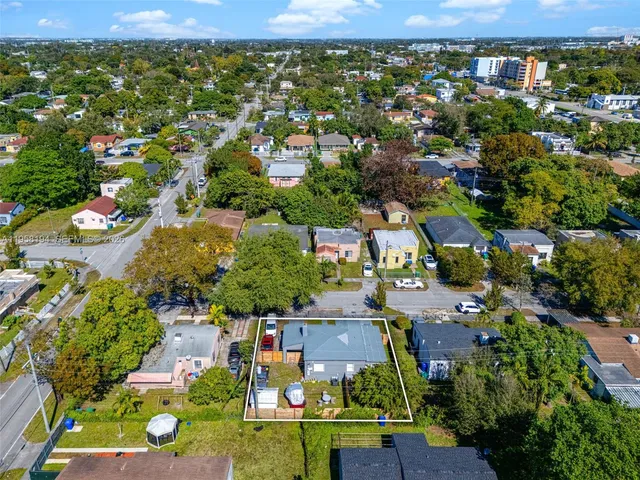 an aerial view of residential houses with outdoor space and street view
