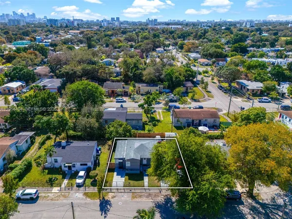an aerial view of multiple houses with yard