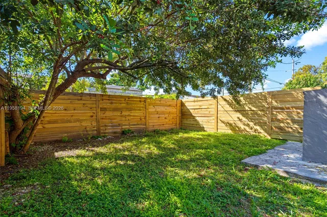 a view of a yard with large trees