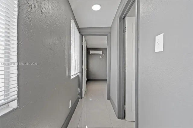 a view of a hallway with wooden shelves