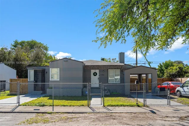 a view of a house with pool and a yard