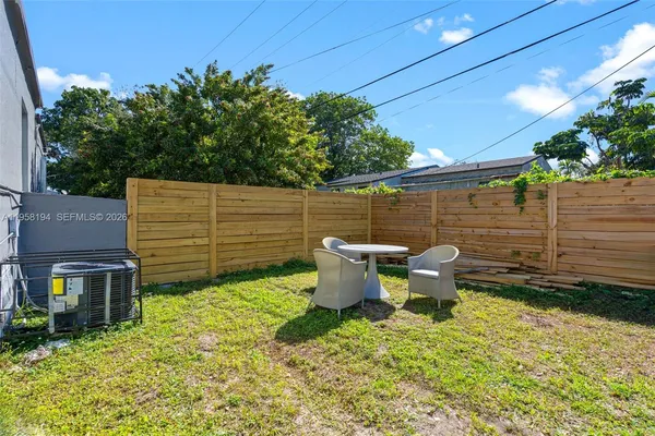 a backyard of a house with outdoor seating
