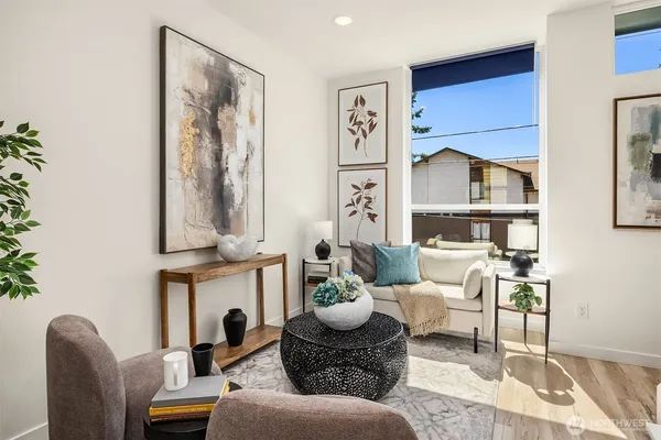 a living room with furniture and a painting on the wall