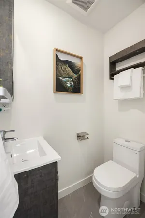 a bathroom with a toilet a sink and mirror