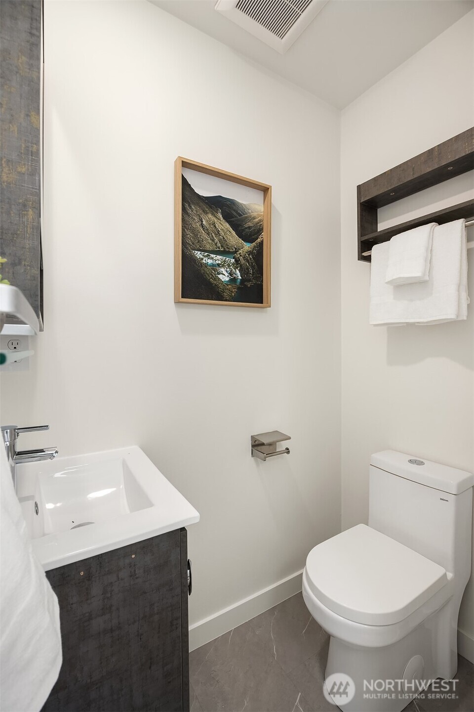 1402 North 95th Street Seattle, WA 98103 - Photo 16 of 31 a bathroom with a toilet a sink and mirror