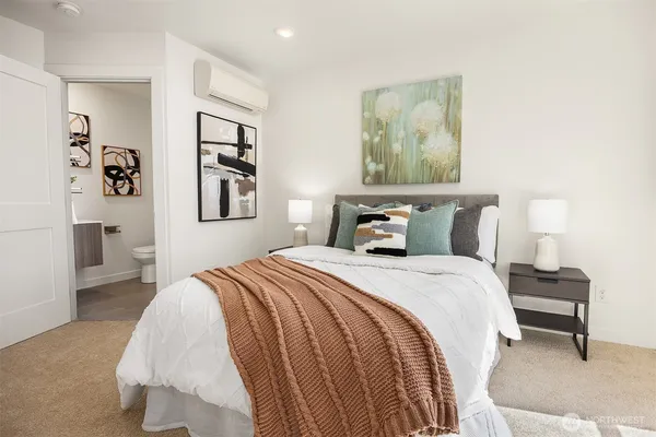 a bedroom with bed and wall painting