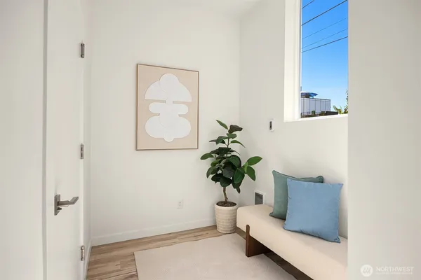 a living room with furniture and a potted plant