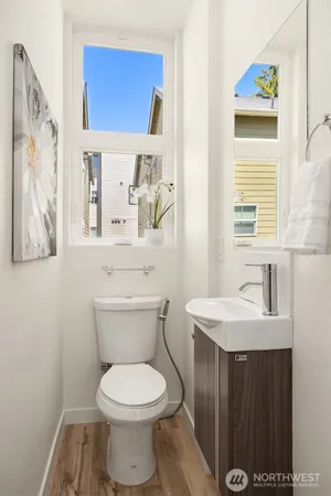 a bathroom with a toilet a sink and a window