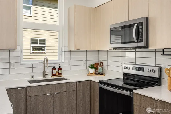 a kitchen with a sink stove and cabinets