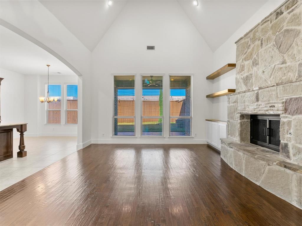 13192 Mapleton Drive Frisco, TX 75035 - Photo 15 of 40 an empty room with wooden floor and fireplace