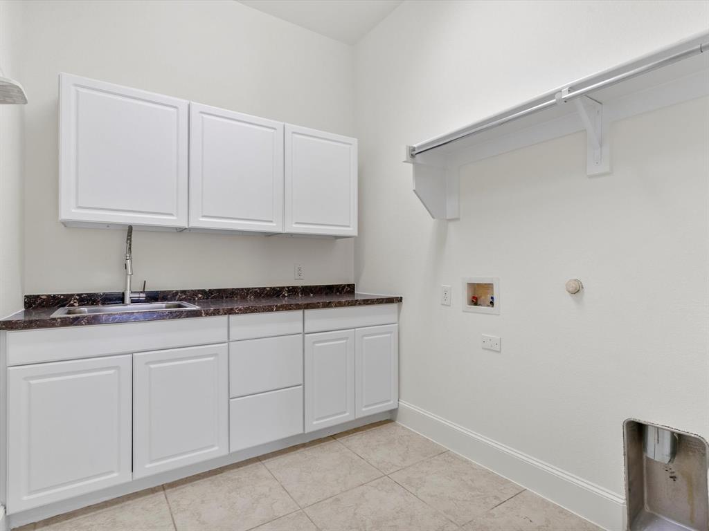 13192 Mapleton Drive Frisco, TX 75035 - Photo 18 of 40 a kitchen with granite countertop white cabinets and a sink