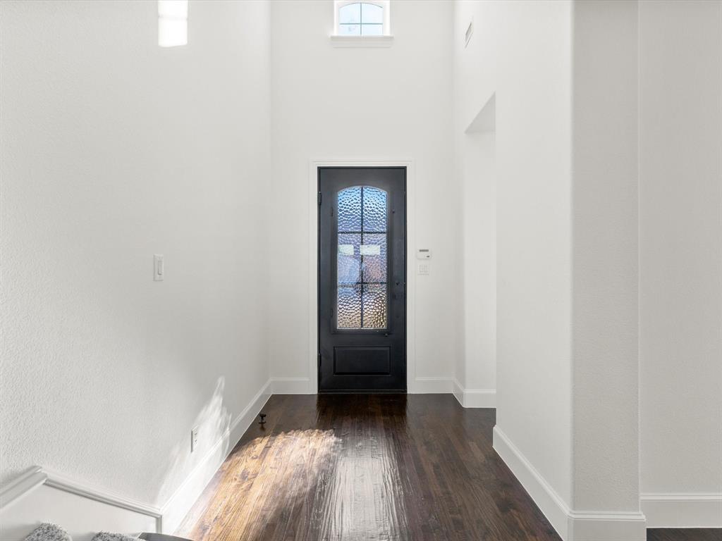 13192 Mapleton Drive Frisco, TX 75035 - Photo 3 of 40 a view of an empty room with wooden floor and a window
